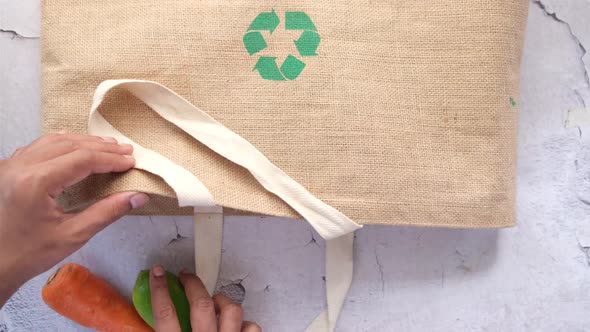 Recycled Arrows Sign on a Shopping Bag with Vegetable