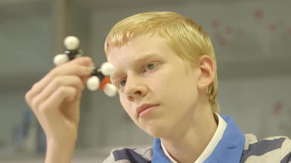 CU Schoolboy trying out a scientific equipment