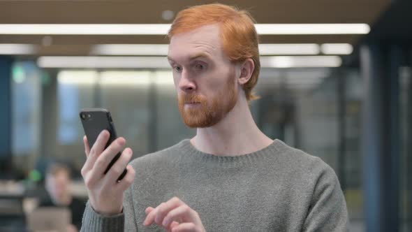 Portrait of Young Man Celebrating on Smartphone