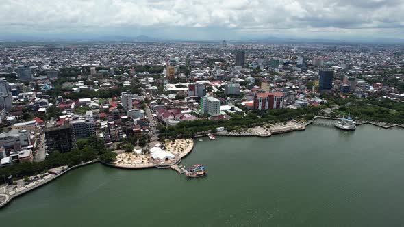 aerial view of large buildings in Makassar city Sulawesi Indonesia on a sunny day along the water.
