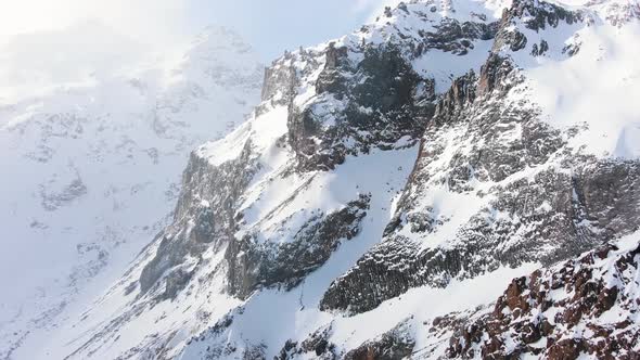 Slopes of Large Mountains Covered with Shiny Snow in Morning