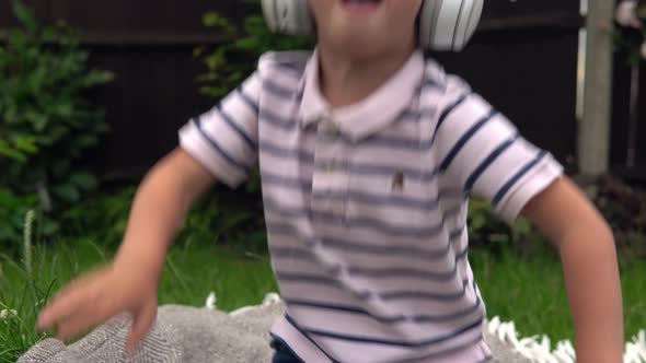 Handsome Smiling Boy Listening to Music on Headphones