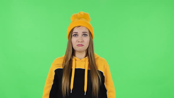 Portrait of Modern Girl in Yellow Hat Upset and Starts To Cry