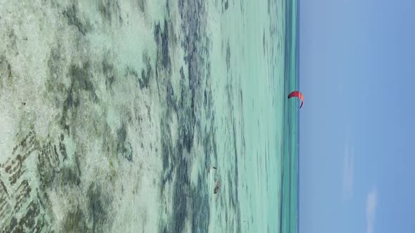 Vertical Video Kitesurfing Near the Shore of Zanzibar Tanzania Aerial View