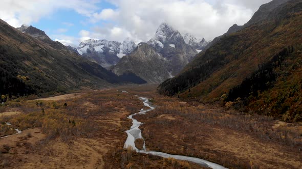 Autumn Mountain Valley with a River High in the Mountains with High Cliffs and Mountains and Epic