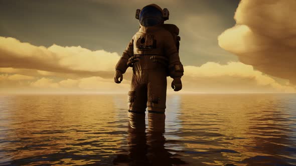 Spaceman in the Sea Under Clouds at Sunset