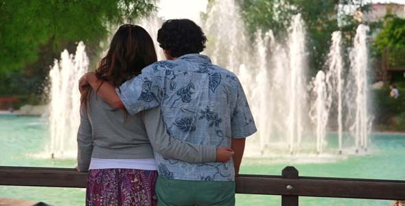 Couple Standing In Front Of Fountain In A Local Pa