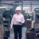 Engineer in Hard Hat is Moving Through a Heavy Industry Factory with a Tablet Computer - VideoHive Item for Sale