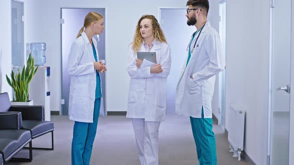 In the Hospital Corridor One Nurse and Two Doctors alt