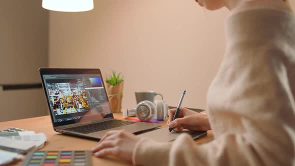 Female Photo Editor Processes Photos on a Laptop at Home Freelancer at Remote Work in Quarantine