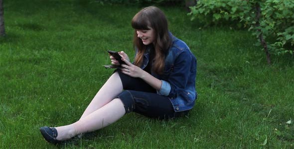 Girl With Mobile Phone In The Garden 2