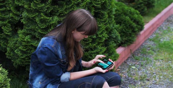 Girl With Mobile Phone In The Garden 3
