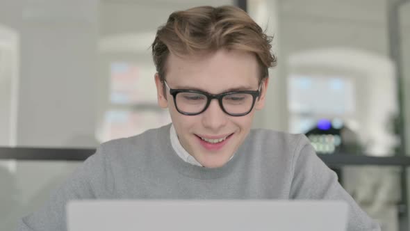 Close Up of Young Man Celebrating Success While Using Laptop