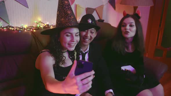 A Group of Friends in Creepy Costumes Communicate Via Video Link Via Phone and Laugh on Halloween