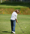 Young golfer performs a golf shot from the fairway. - PhotoDune Item for Sale