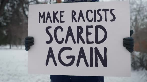 Man protests against the police officers and says make racists scared again