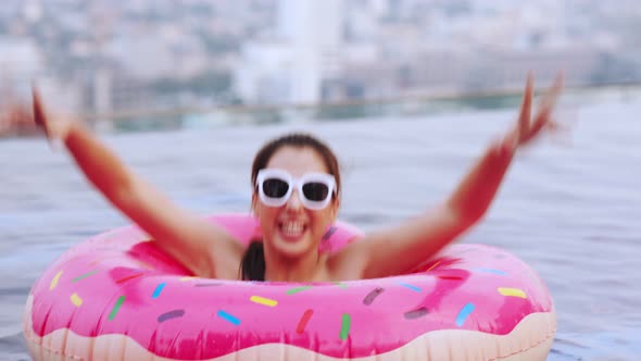 Asian young woman relaxing in swimming pool at luxury hotel