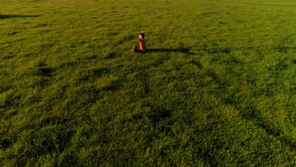 Low Altitude Radial Flight Over Sport Yoga Man at Perfect Green Grass