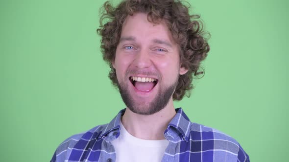 Face of Happy Young Bearded Hipster Man Smiling and Laughing