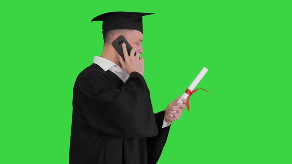 Graduating Student Walking and Making a Call on a Green Screen, Chroma Key.