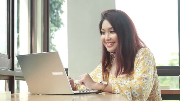 Young asian women in online meeting with laptop in desk