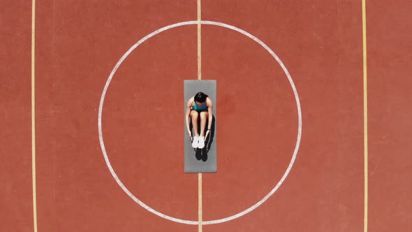 Aero, Top View, Fitness Woman in Sportswear Doing Various Exercises. Background of Orange Basketball