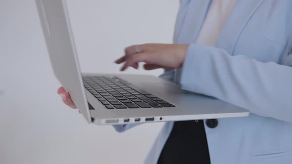 Closeup of Female Hands on the Laptop Keyboard