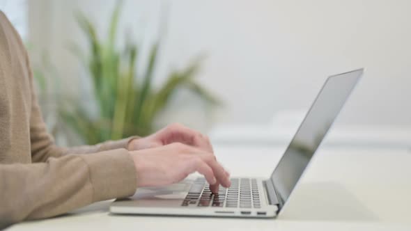 Close Up of Man Typing on Laptop