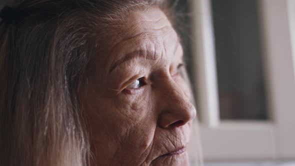 Lonely Old Woman Blinking and Turning Her Head to Look Back