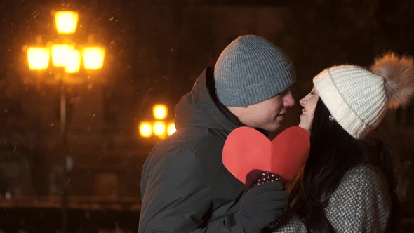 Close Up of Male and Female Hands Holding Sign of Love