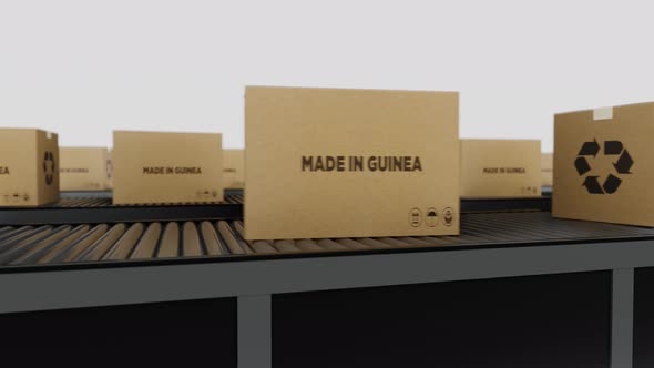 Boxes with MADE IN Guena Text on Conveyor