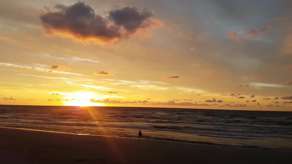 Sunset at the Lubiatowo Beach, Baltic Sea, Poland. Beautiful colours. Single person walking