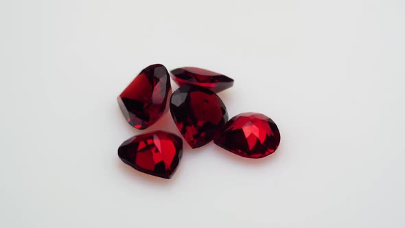 Natural Red Garnet Gemstone on the White Background on the Turning Table