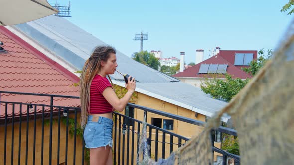 Young Woman Drinks Argentine Mate Tea at Home or Hotel