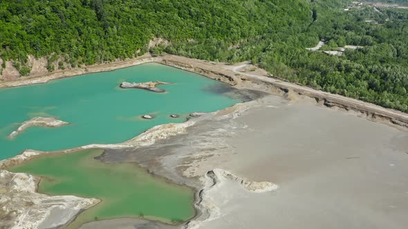 Drone View of a Dam with a Turquoise Lake