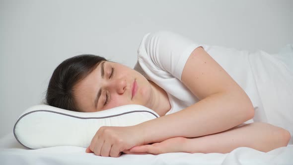 A Woman Tries to Fall Asleep on an Uncomfortable Pillow Rolls Over From Side to Side