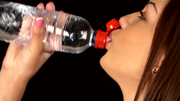 Beautiful, Sporty Woman Drinking Water, on Black, Close Up