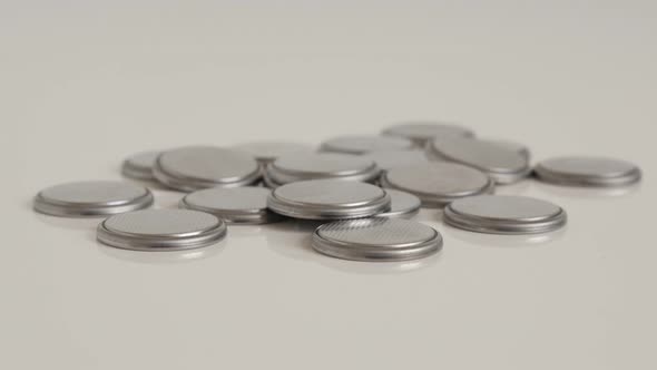 Many button watch batteries close-up 4K tilting footage