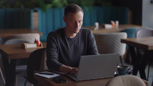 Beautiful Male Developer or Student Working Studying By Laptop in Cafe