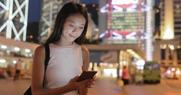 Woman using mobile phone in the city