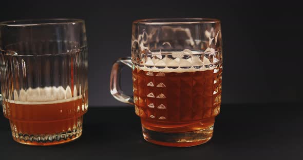 Pouring Beer Into Glass Over Dark Background