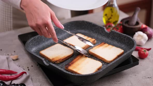 Toasting Slices of Toast Bread in a Grill Frying Pan