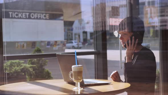 Adult Female Talking By Mobile in Bar.