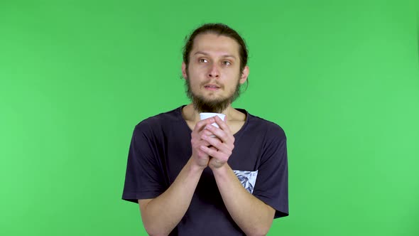 A Portrait of a Darkhaired Bearded Man Holding a Cup of Coffee Inhales the Smell of Aromatic Coffee