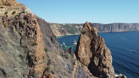 Aerial View From Above on Calm Azure Sea and Volcanic Rocky Shores