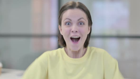 Portrait of Excited Young Woman Celebrating Success