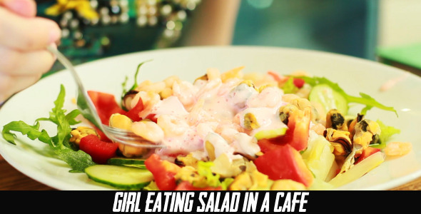 Girl Eating Salad In A Cafe