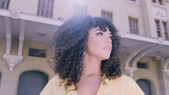 Young Afro-American Woman with Curly Hair Looking at Camera and Smiling