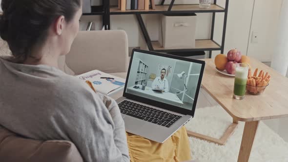 Pregnant Woman Talking with Doctor on Video Call