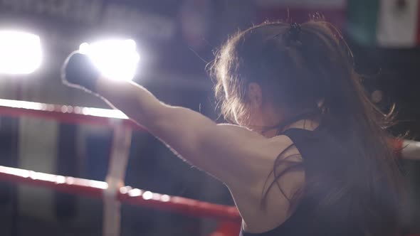 Female Boxer Performing Punching in Bandages in Slow Motion